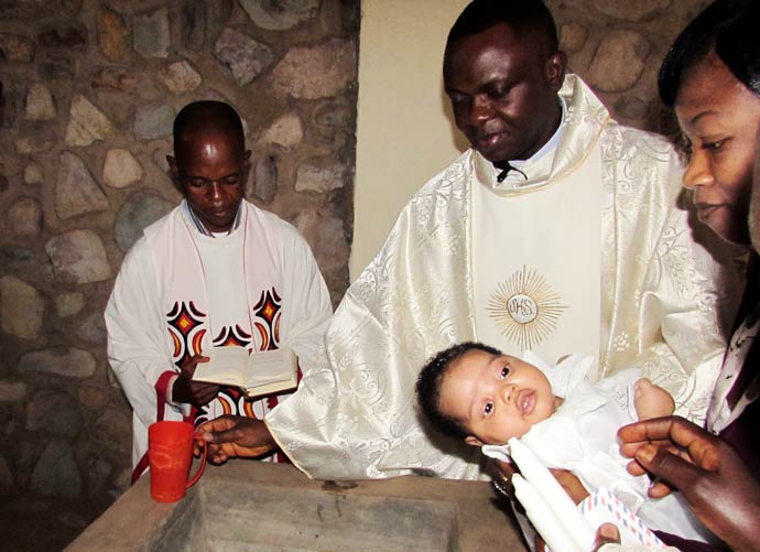Father Apollinaire Cibaka Cikongo is baptizing a little child during holy mass