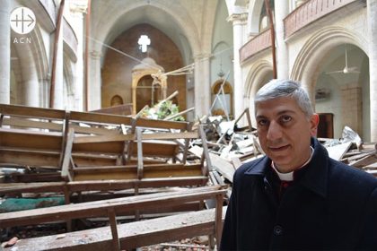 Maronite Archbishop Joseph Tobji of Aleppo in bombed Maronite Cathedral, Old City, Aleppo, Syria.