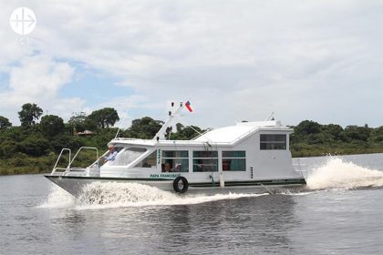 Boat Pope Francis, a boat donate with help of ACN for Tefé: Father Pedro (Piotr) Schewior on board of the boat.