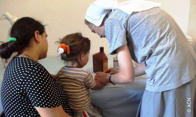 A religious sister from the parish of Saranda helps with outpatient care.