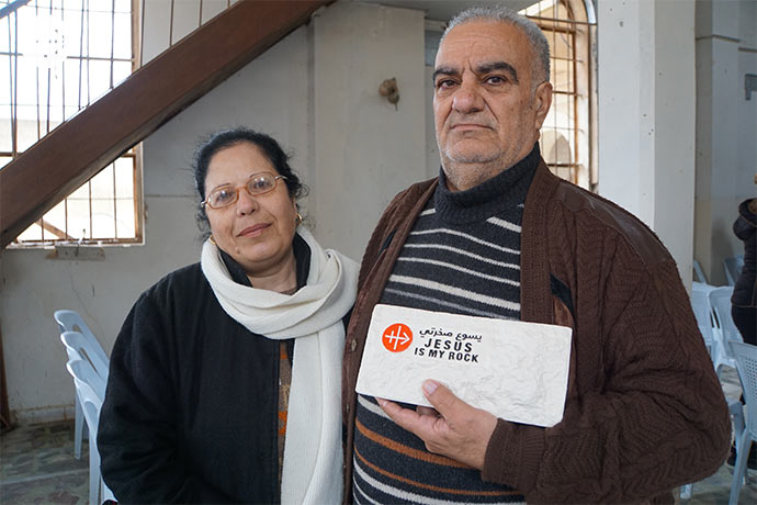 Homecomers Hasan Marmari and his wife Halloun Jreij with the Jesus is my Rock stone tablet.