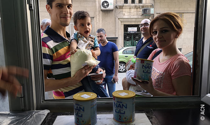 At the distribution point of the relief campaign “A Drop of Milk”.