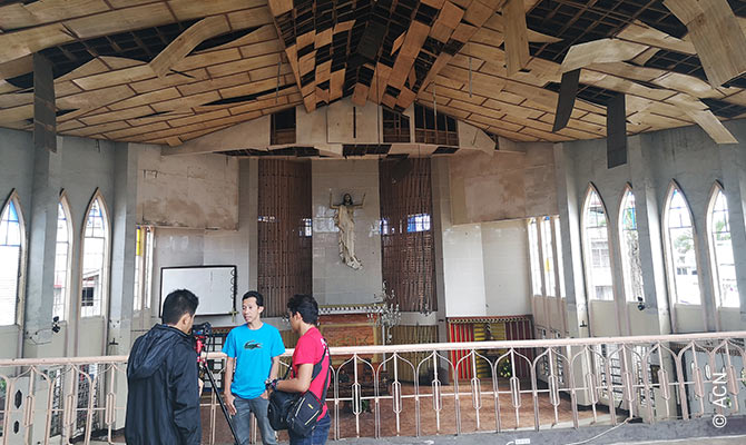 Rector P. J. Nacua in the bombed-out Cathedral of Our Lady of Mount Carmel, Jolo.