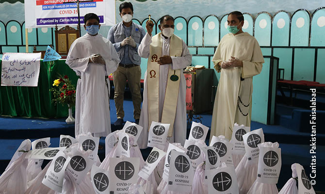 Faisalabad: Priests blessing the food packages.