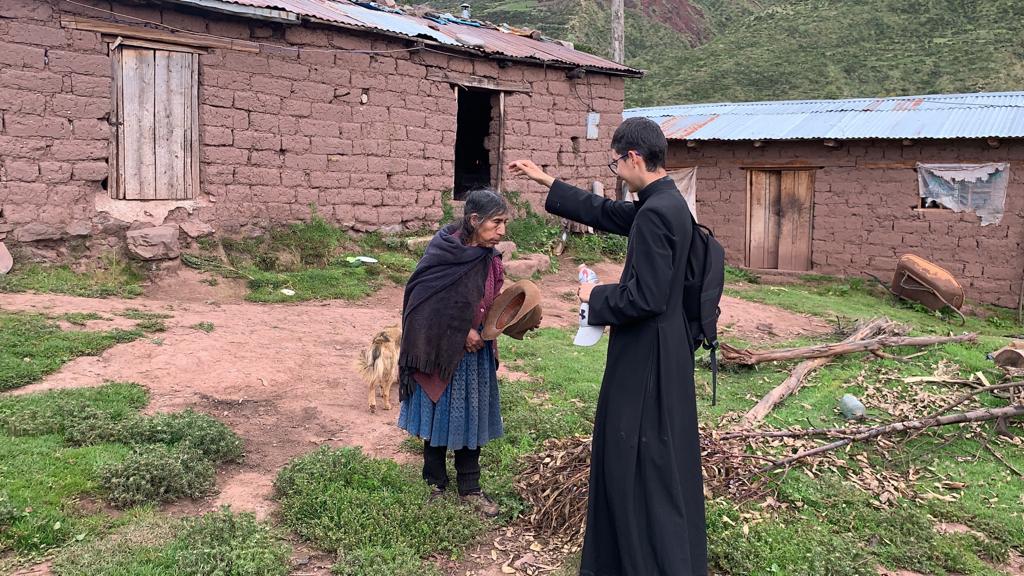 Peru: a priest blessing a believer.