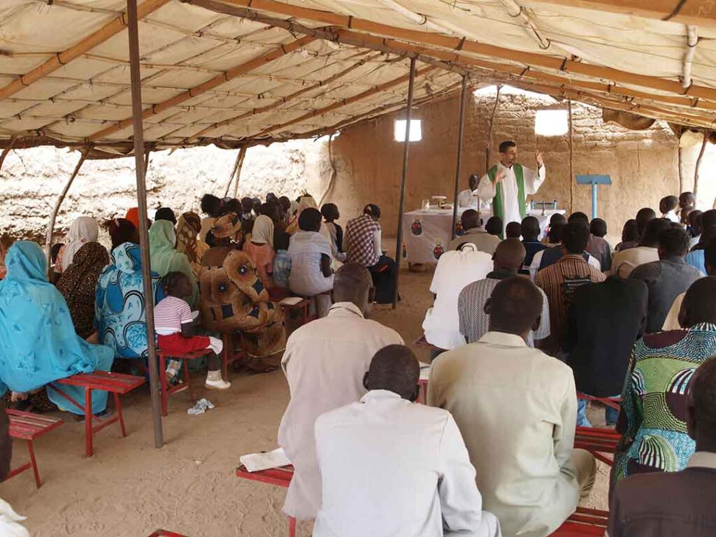 Father Jorge Naranjo with his community in Sudan
