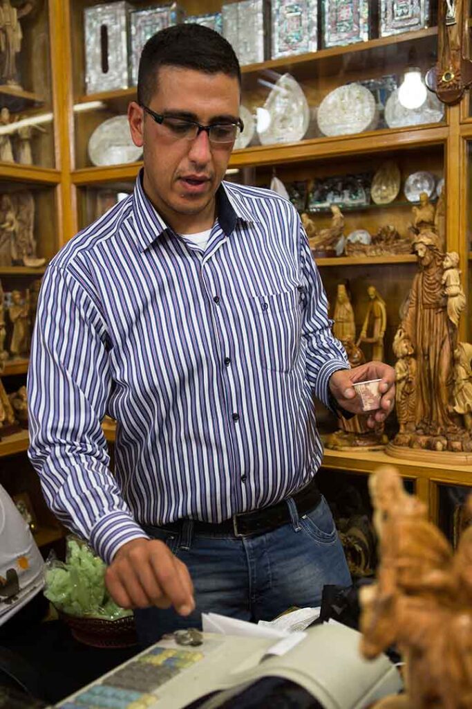 Rony Tabash behind the counter of Nativity Store in Bethlehem
