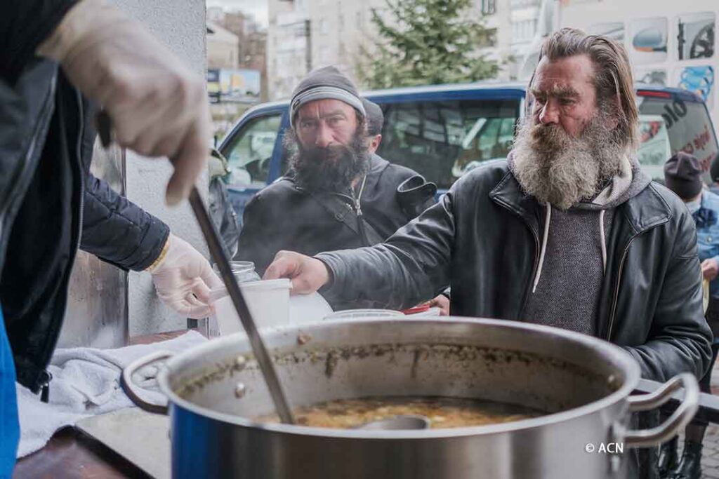 People in need receive a hot meal at the Albertine Brothers' homeless shelter in Lviv