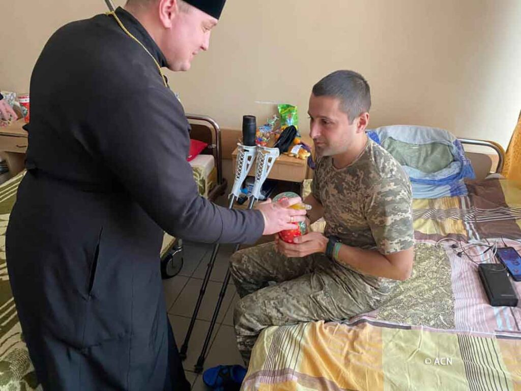 Un sacerdote visitando y ofreciendo apoyo a un soldado convaleciente