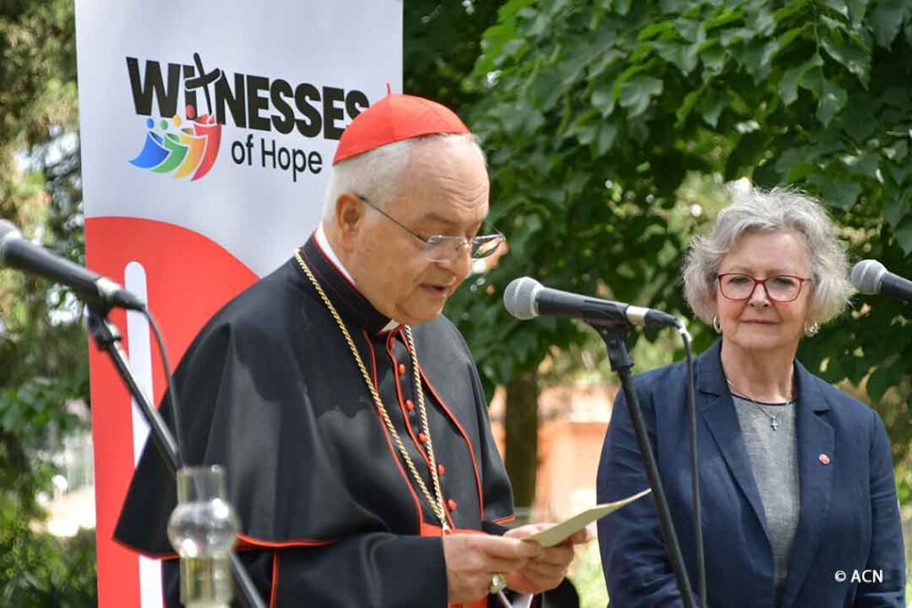 Cardinal Mauro Piacenza, president of ACN, and Regina Lynch, executive president, address the pilgrims