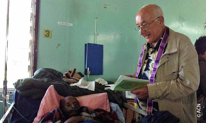 A priest visiting sick people in a hospital.